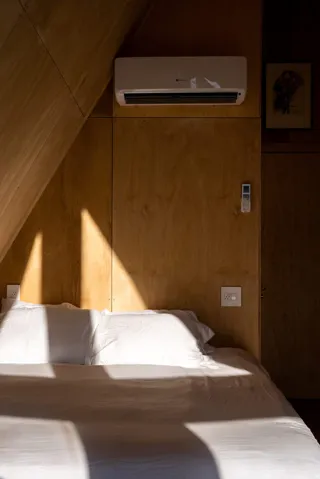 Bedroom featuring lofted ceiling and a mini split for heating / cooling