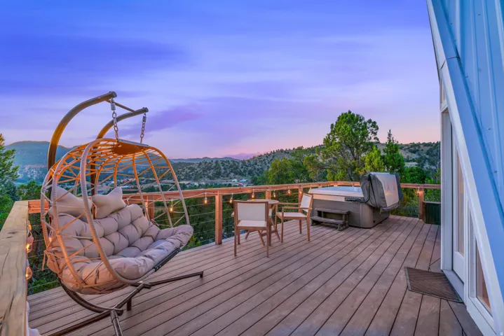 Deck at dusk featuring a mountain view