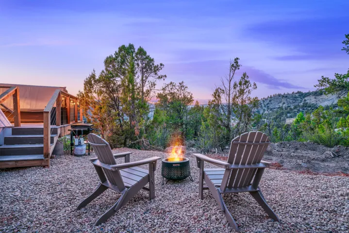 Yard at dusk with an outdoor fire pit and a patio
