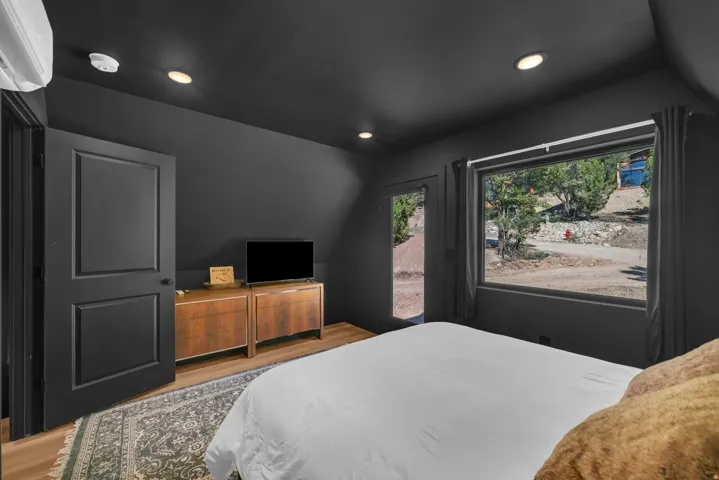 Bedroom with light wood-type flooring, recessed lighting, and access to outside