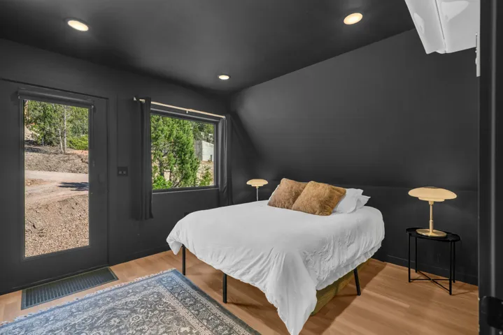 Bedroom with light wood-type flooring, access to outside, and recessed lighting
