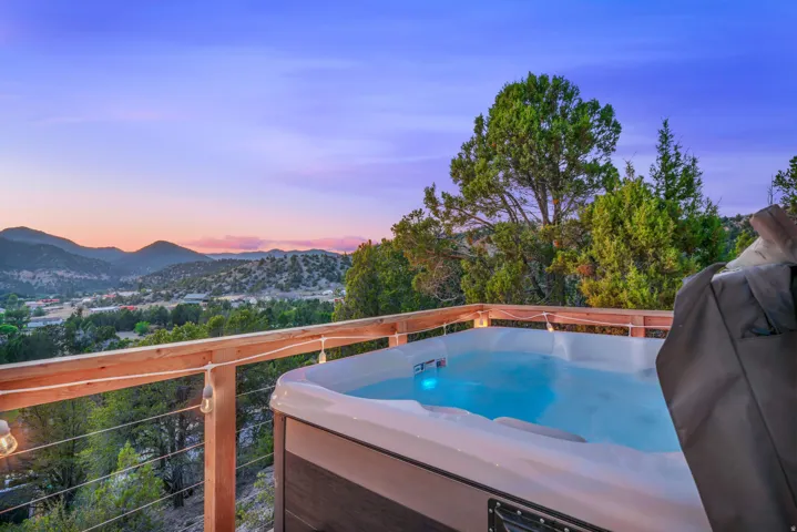 Balcony featuring a hot tub and a mountain view