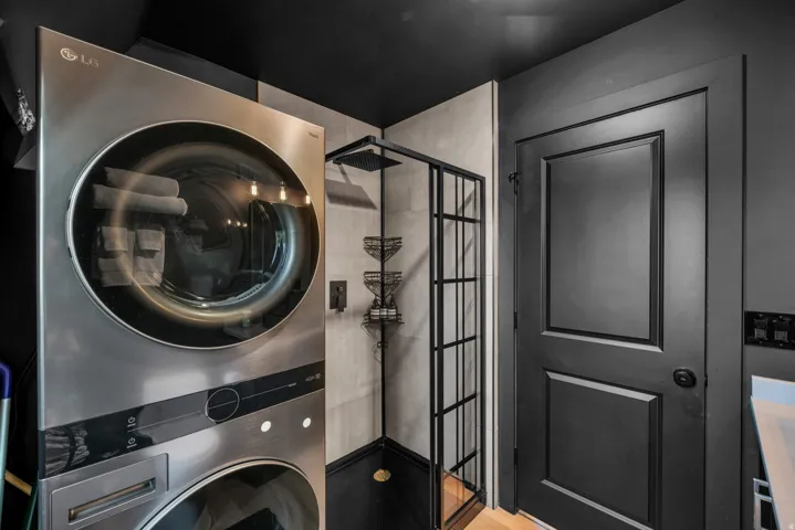 Laundry area with stacked washer and dryer