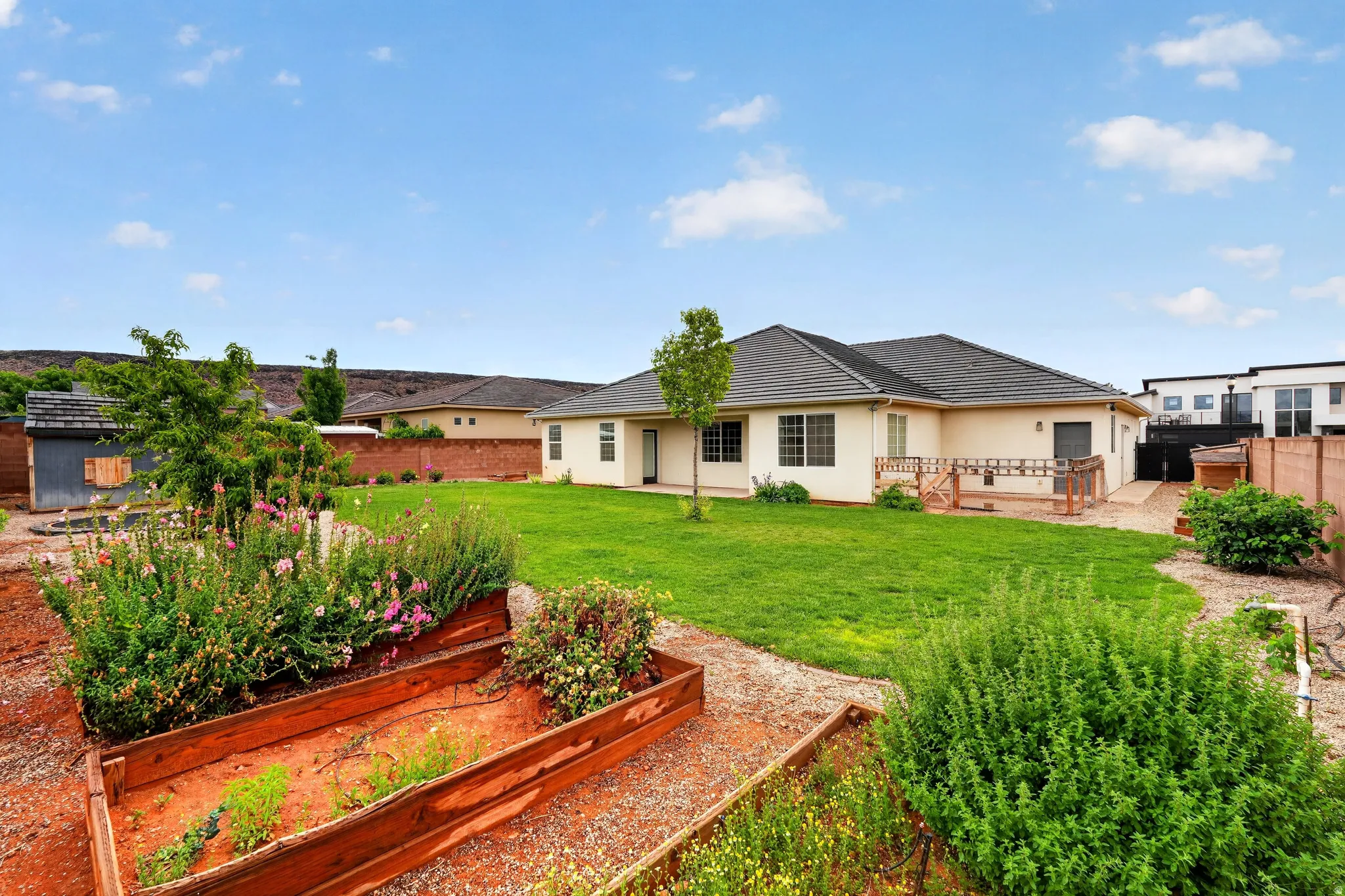 Back of property featuring a fenced backyard, a patio area, and a deck