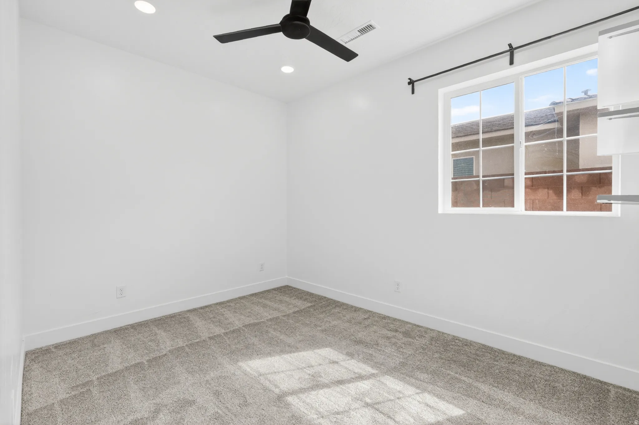 featuring light colored carpet, recessed lighting, and a ceiling fan