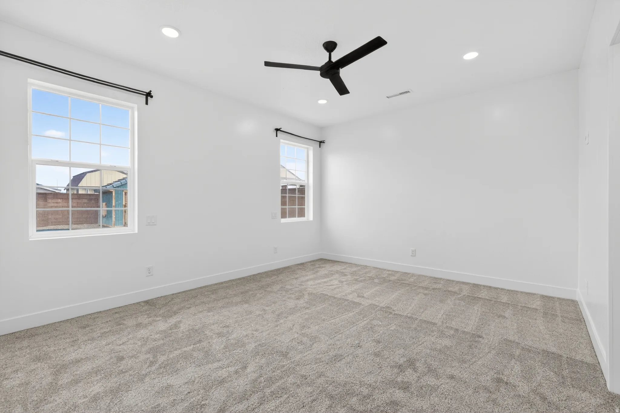 Spare room with light colored carpet, recessed lighting, and ceiling fan