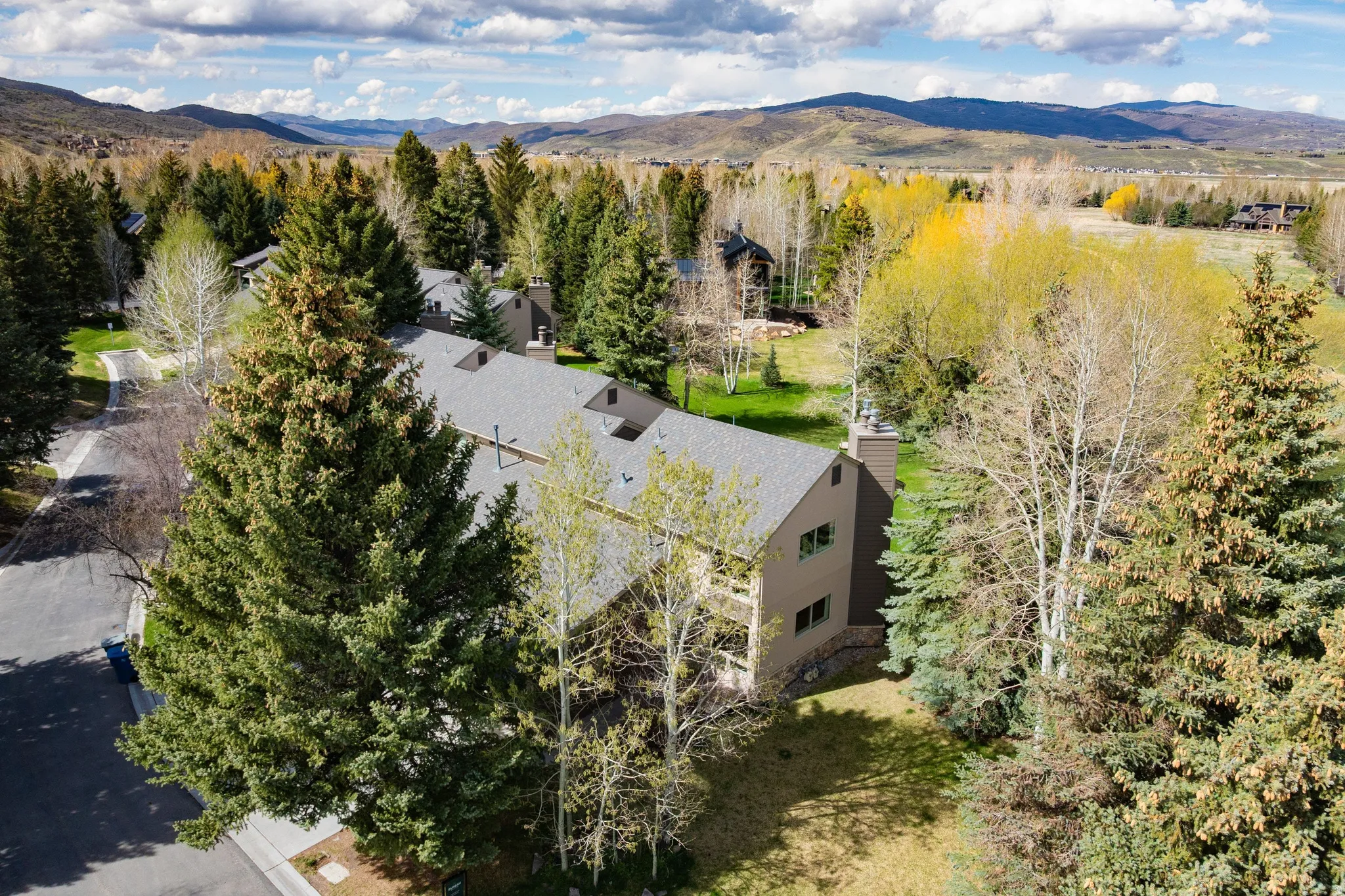 Drone / aerial view of mountains and a tree filled landscape
