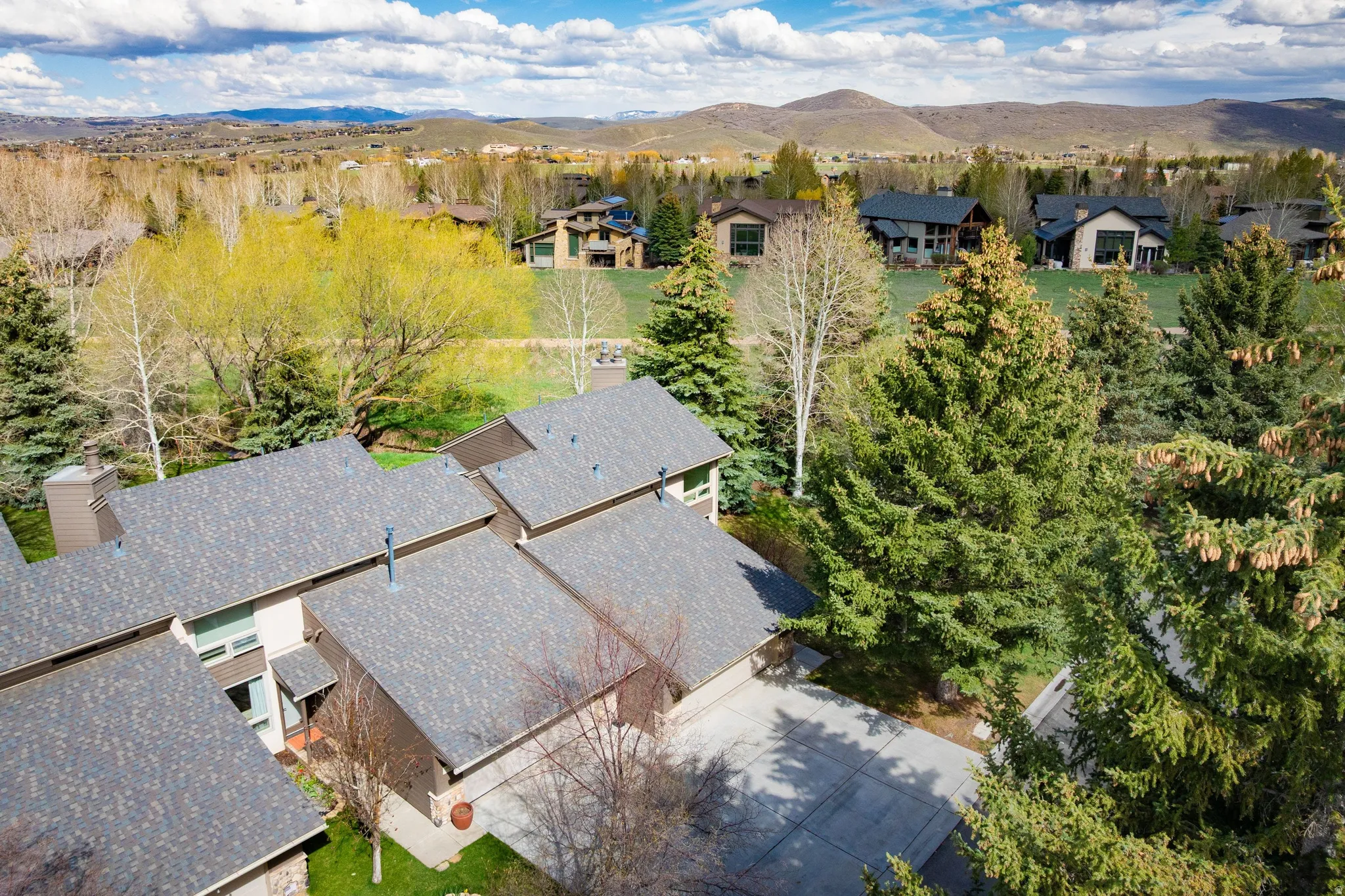Aerial perspective of suburban area with a mountain backdrop