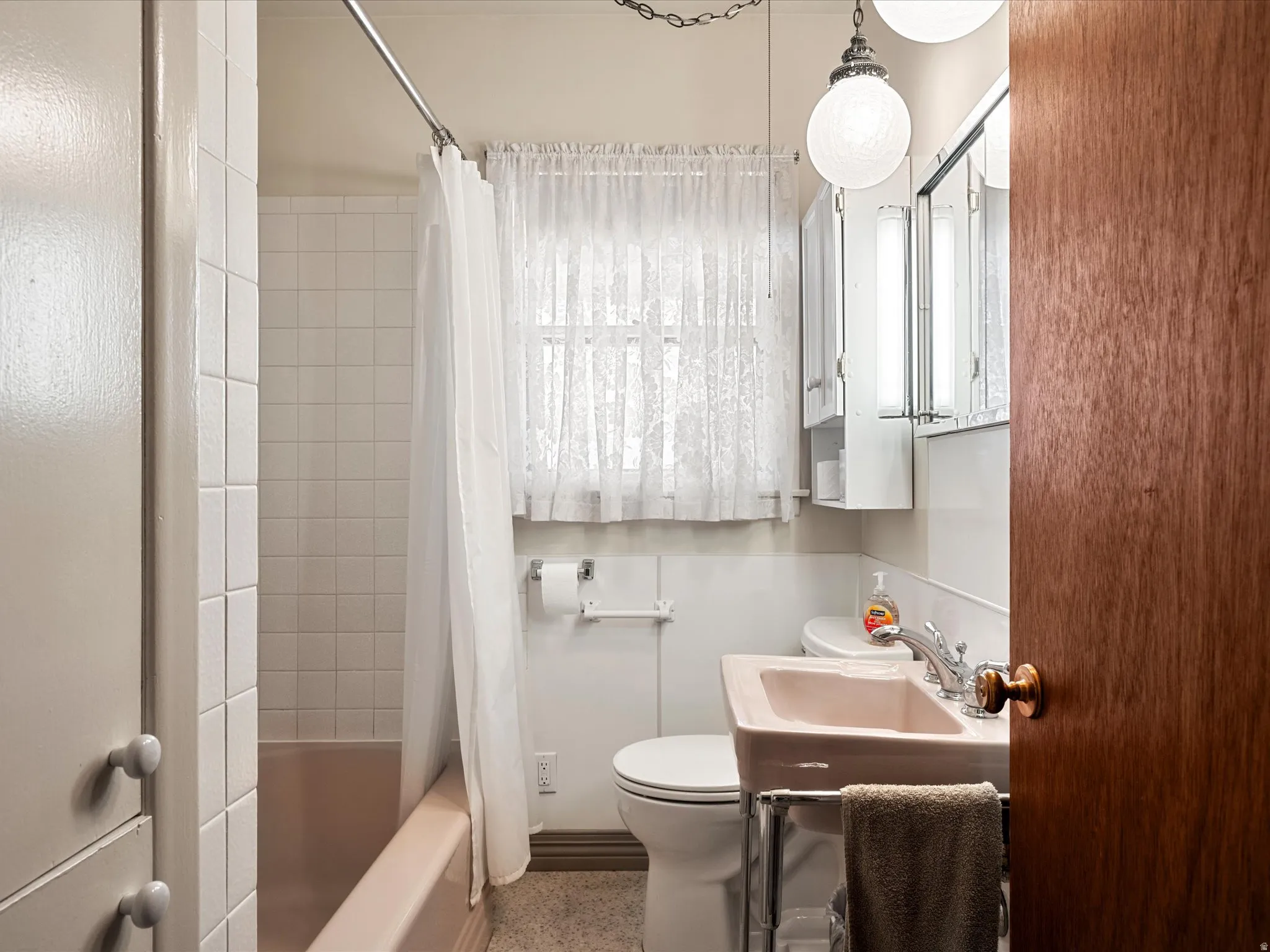 Full bath featuring toilet and shower / bath combo with shower curtain