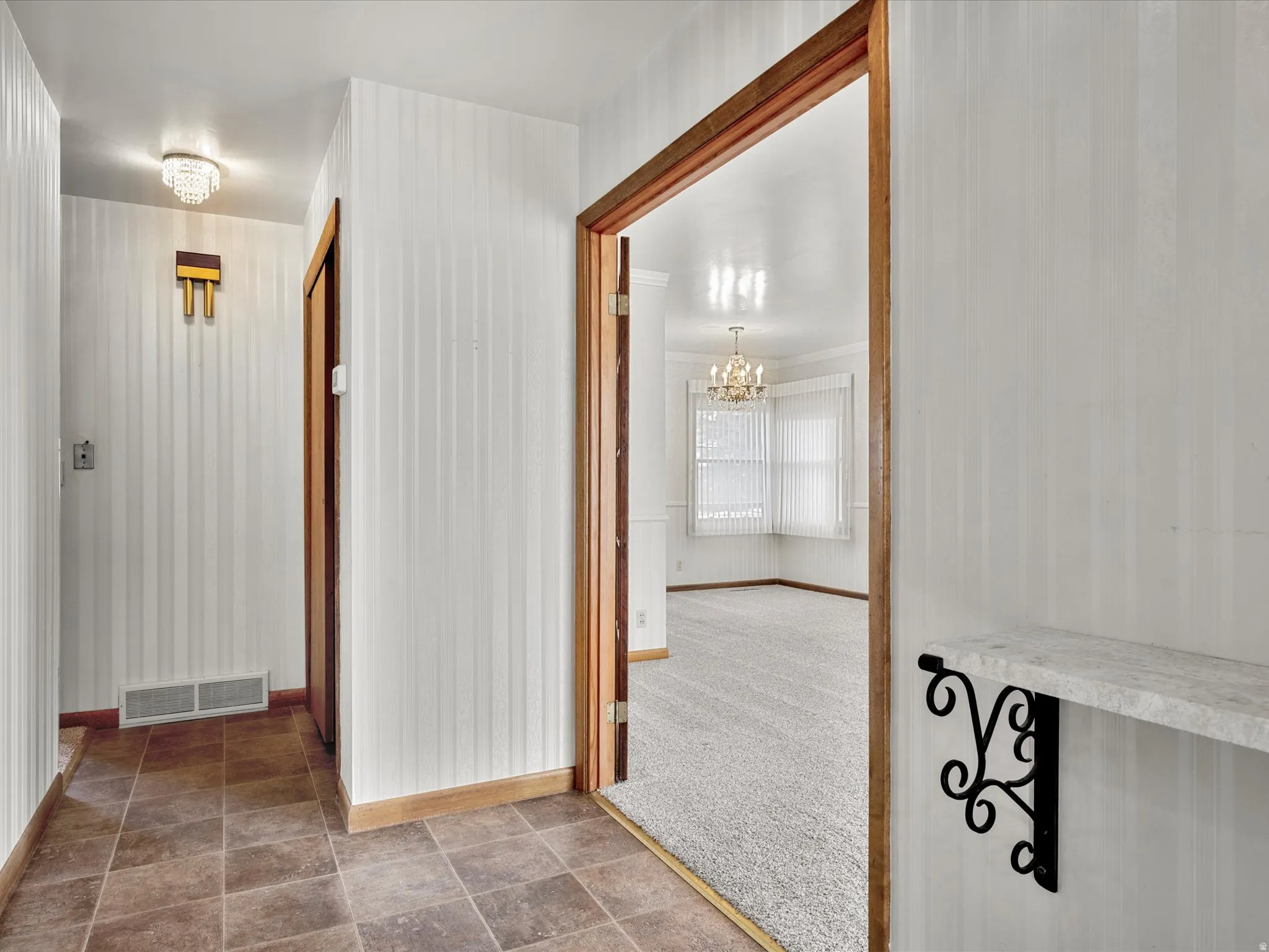 Hall featuring hanging lights and stone finish flooring
