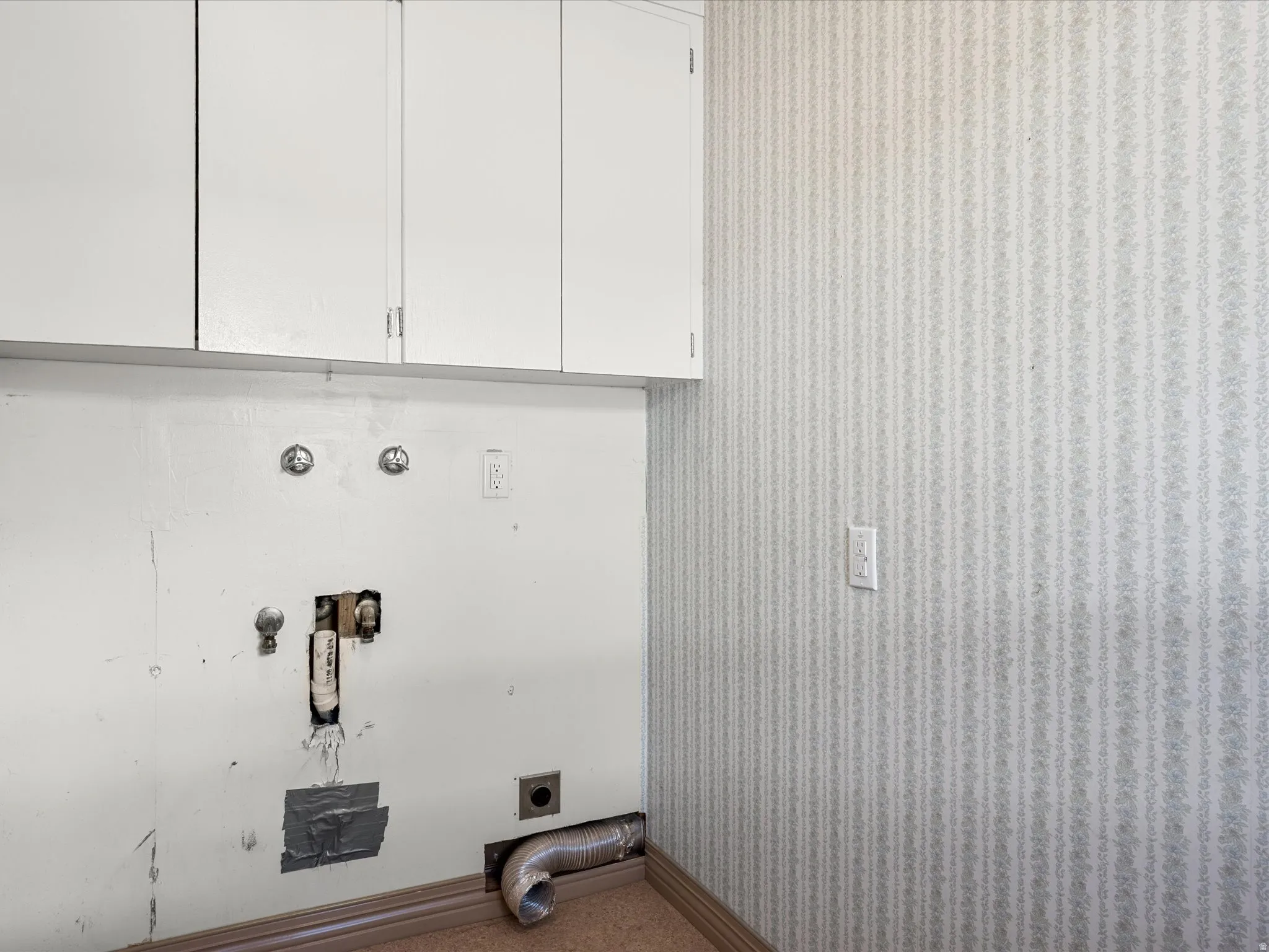 Laundry area featuring wallpapered walls, hookup for an electric dryer, hookup for a washing machine, cabinet space