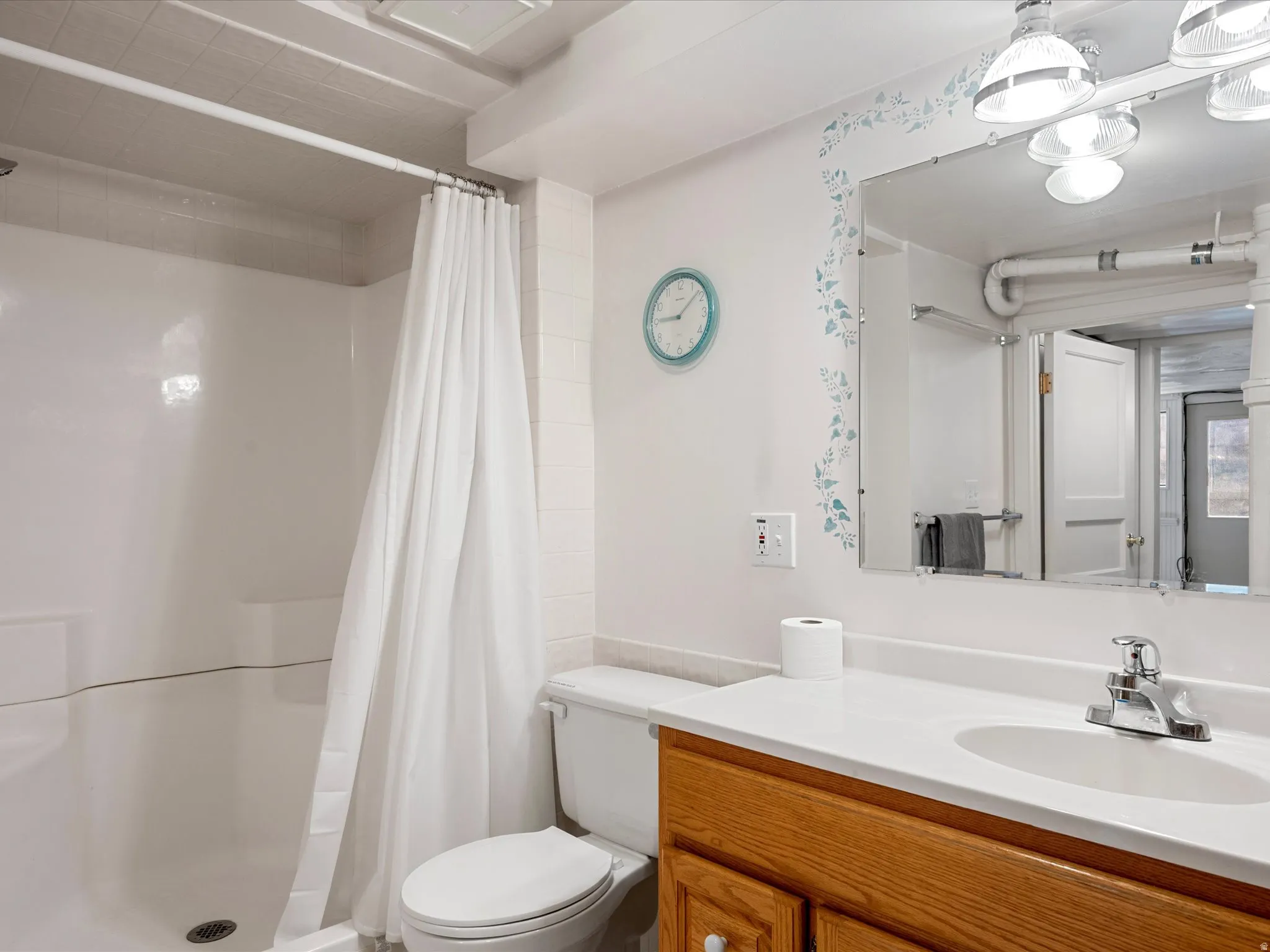 Full bath with a shower stall and vanity