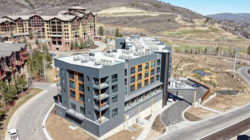 Aerial view of a mountain backdrop and apartment complex / building