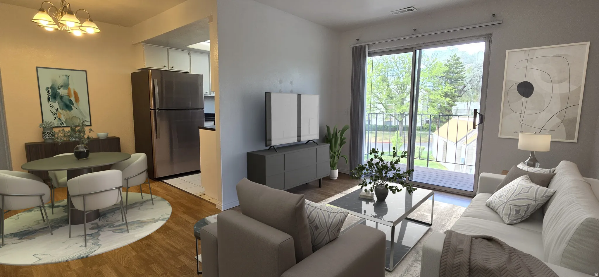 Living room with light wood finished floors and suspended lighting