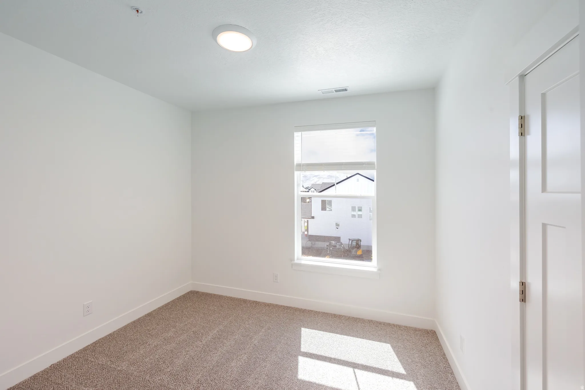 Neutral tone carpeting with white walls and trim