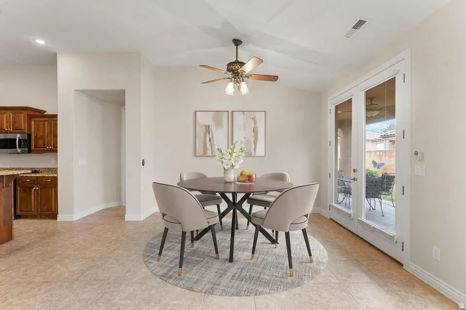 Dining room featuring a ceiling fan and lofted ceiling