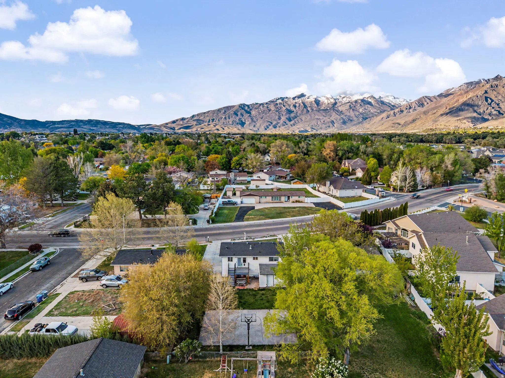 Aerial perspective of suburban area with a mountainous background