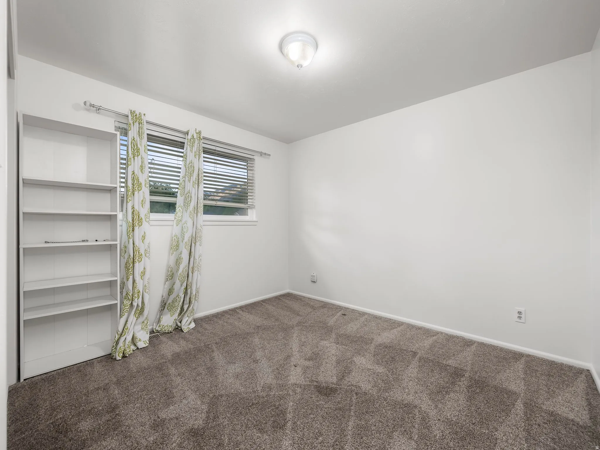 Spare room with dark carpet