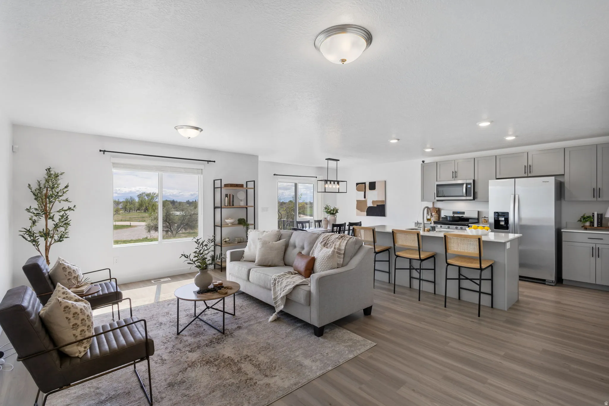 Living area with healthy amount of natural light, dark wood finished floors, and recessed lighting