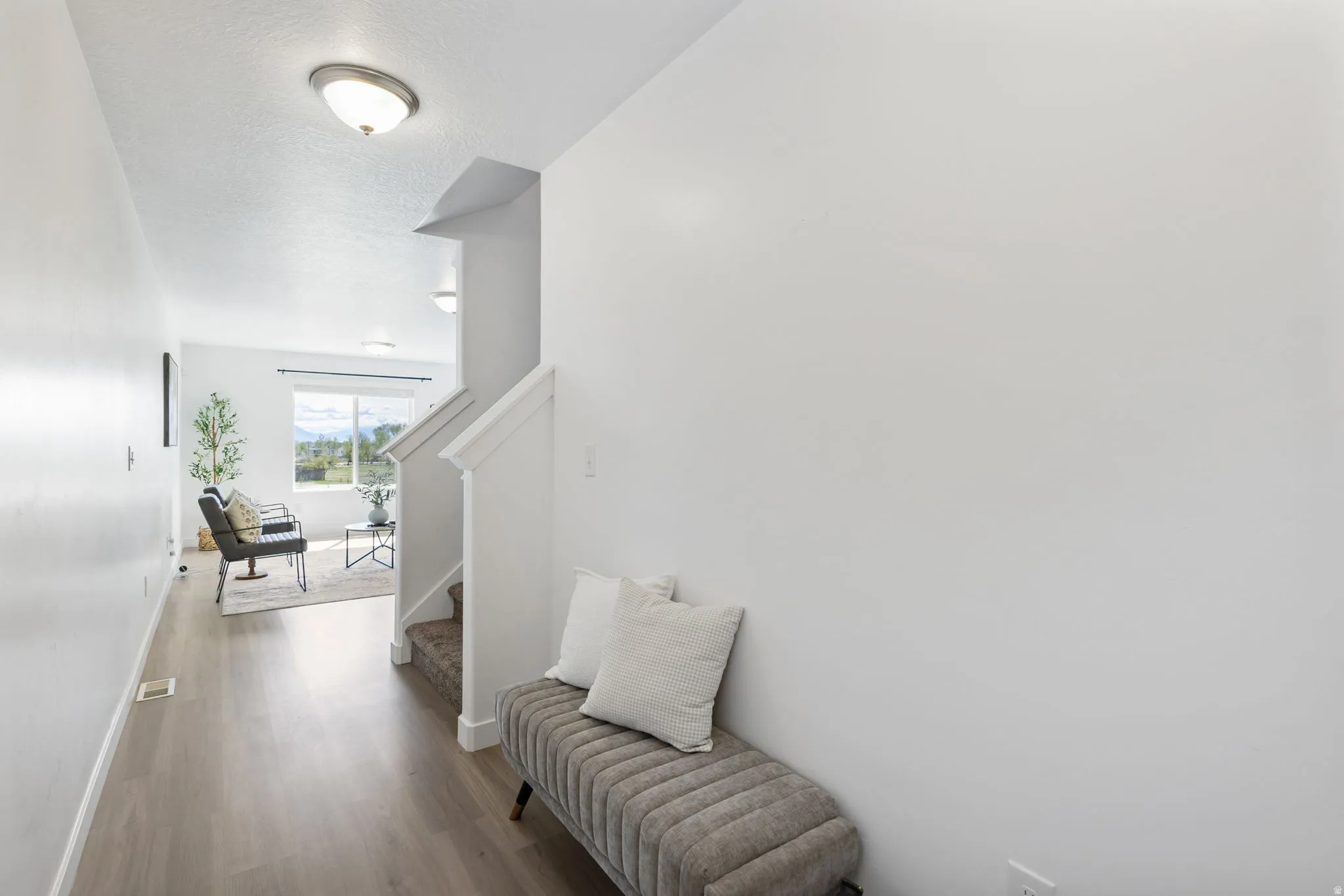Hall with dark wood-style floors and a textured ceiling
