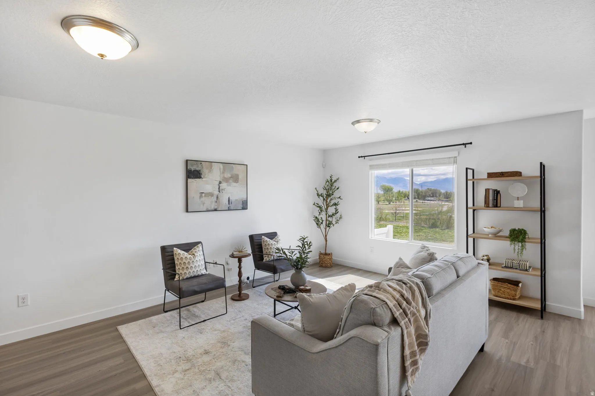Living room featuring wood finished floors and a textured ceiling
