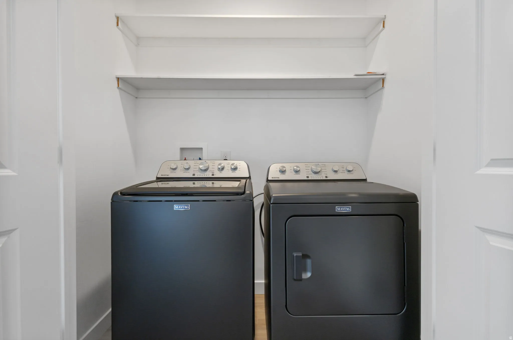 Laundry area with independent washer and dryer and wood finished floors