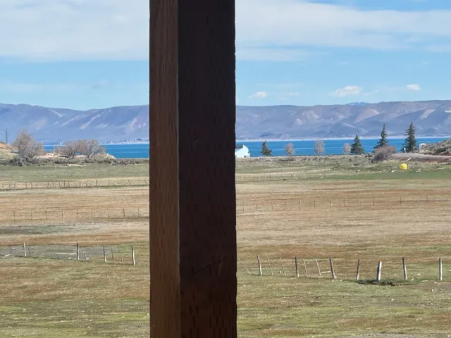 View of mountain backdrop featuring a nearby body of water