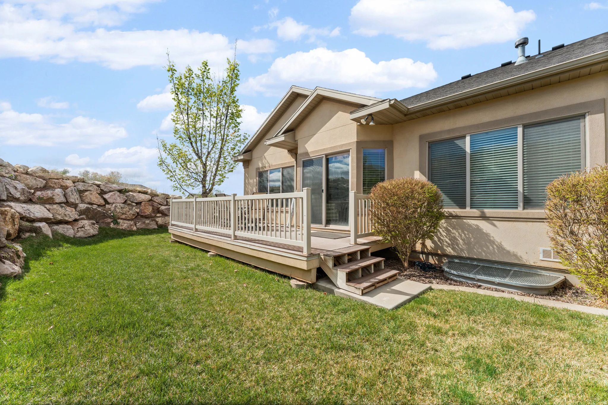 View of green lawn with a deck