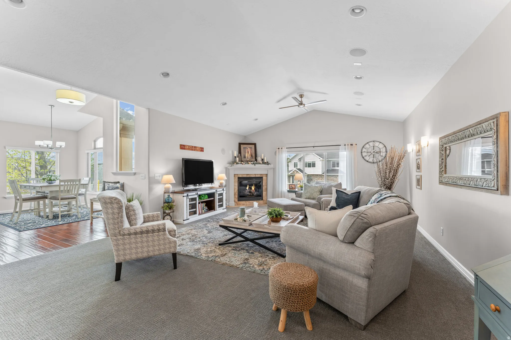 Living area featuring a glass covered fireplace and dark colored carpet