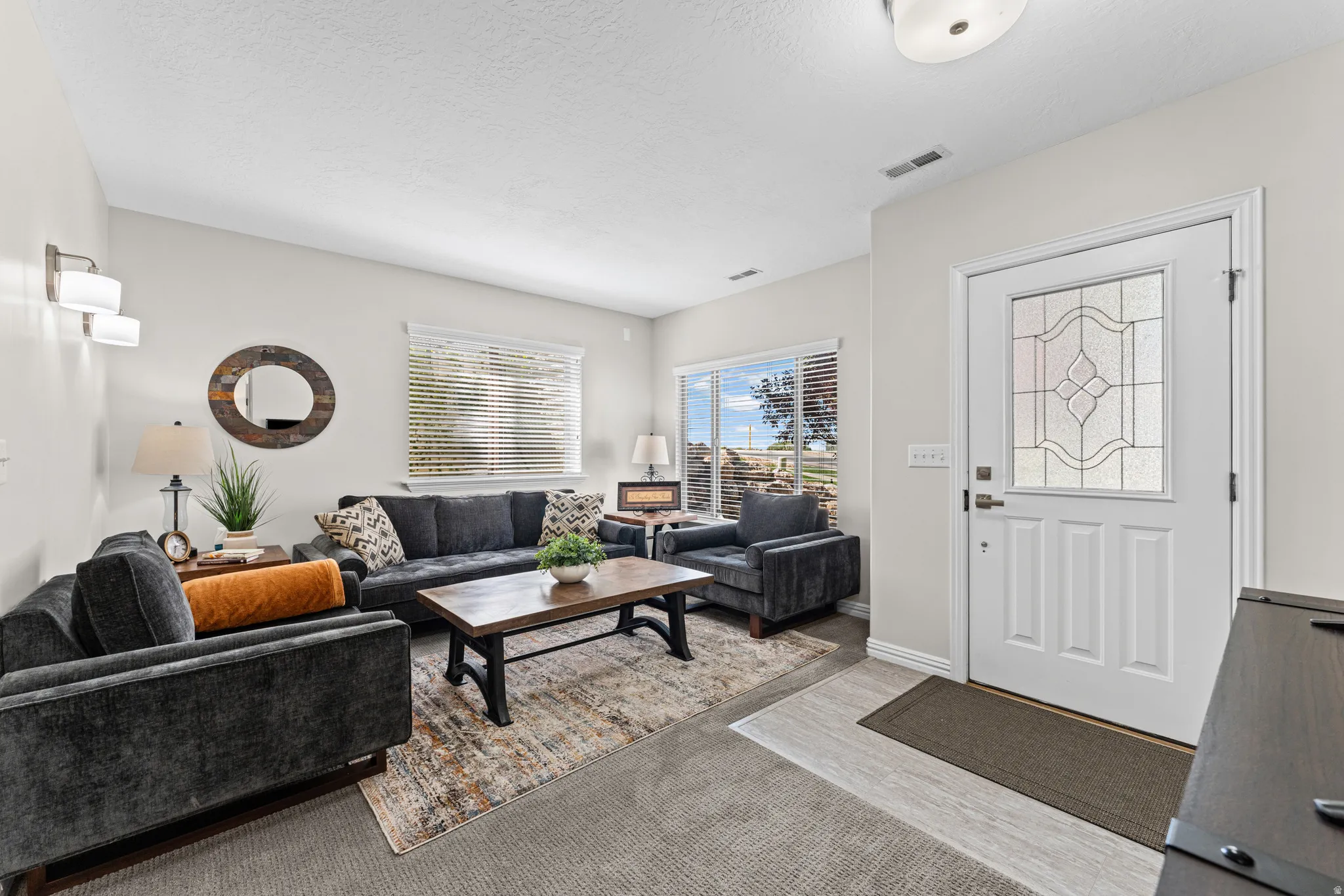 Living room featuring baseboards and a textured ceiling