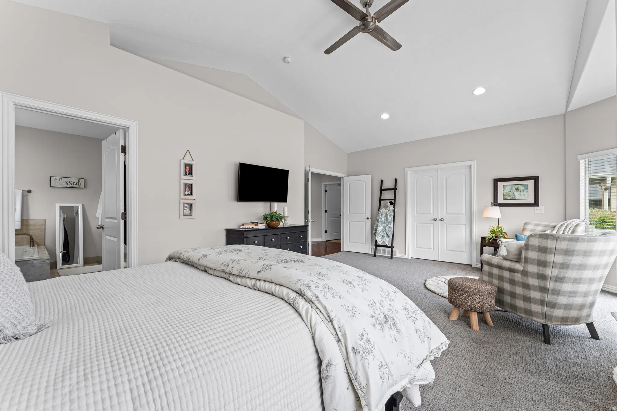 Bedroom featuring a closet, lofted ceiling, recessed lighting, dark colored carpet, and a ceiling fan