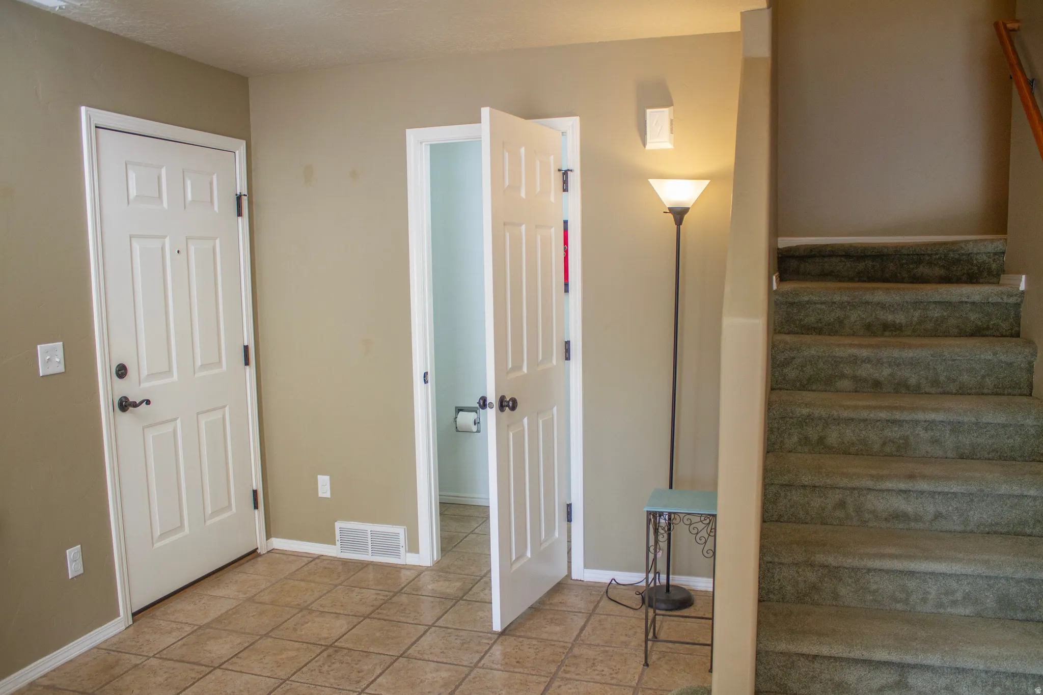 Stairs with baseboards and tile patterned floors