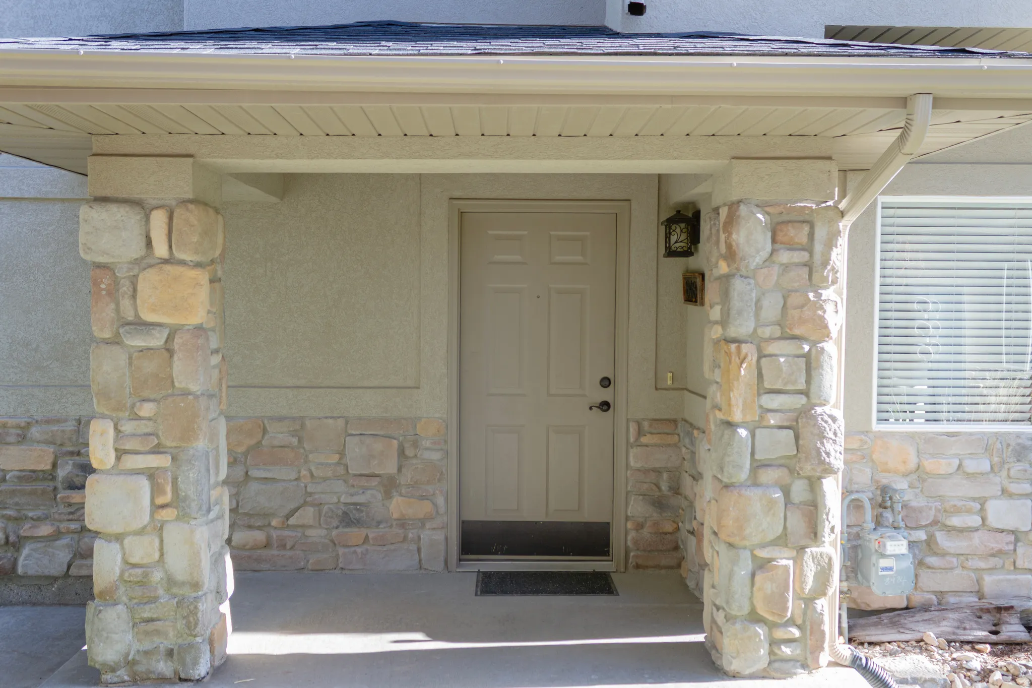 View of exterior entry with stone siding