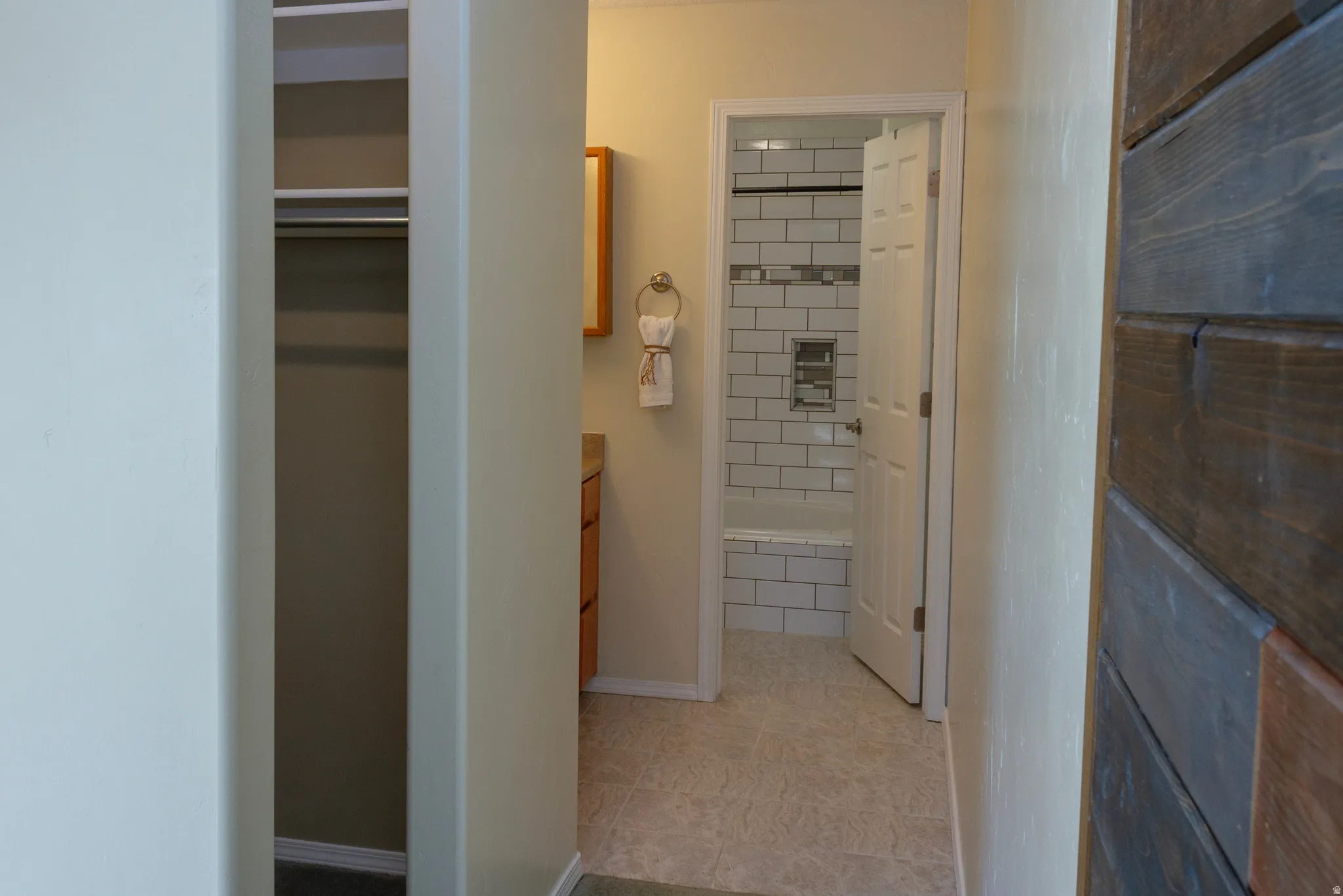 Full bathroom with vanity and baseboards