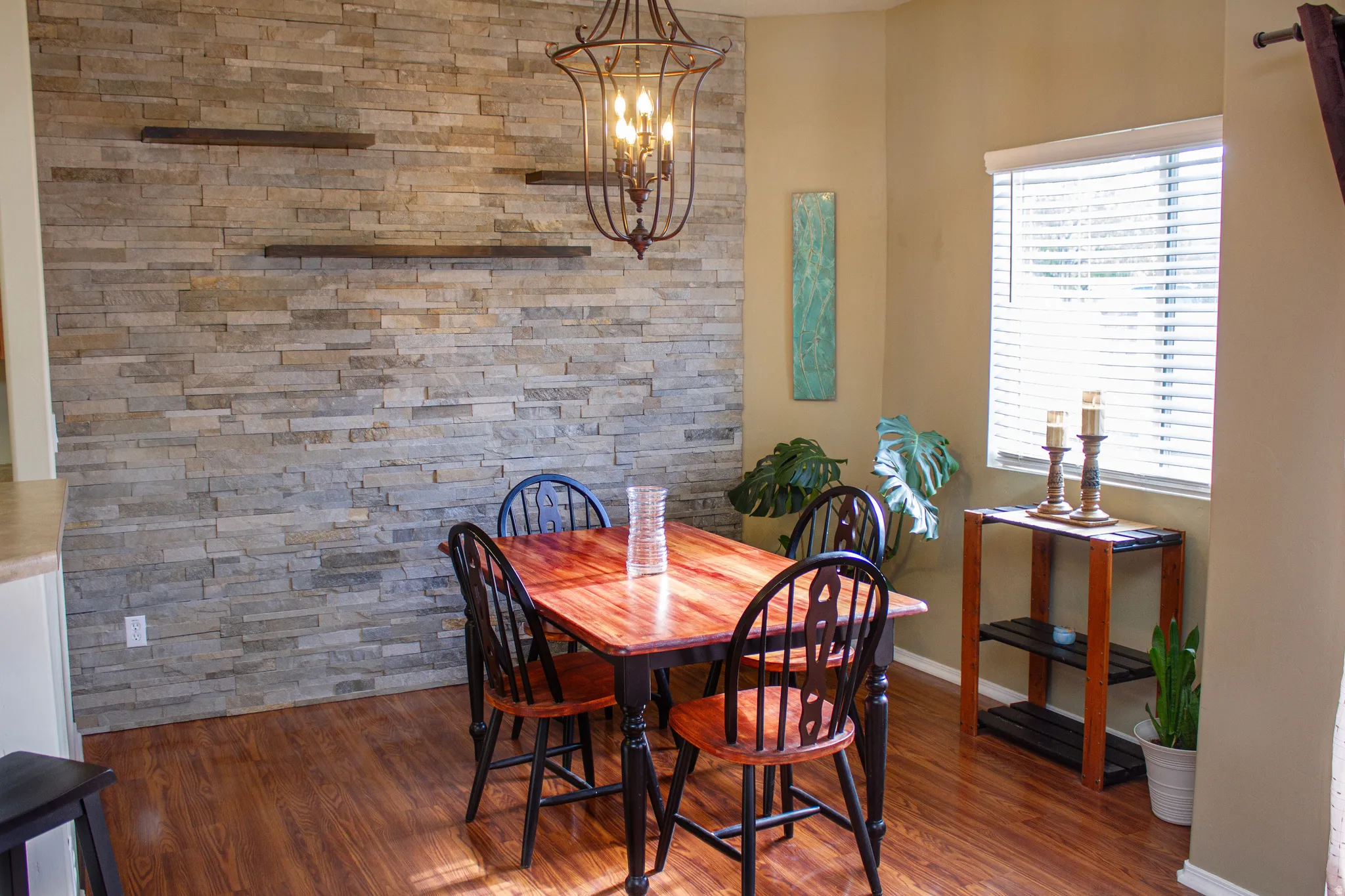 Dining space with dark wood-style floors and hanging lights