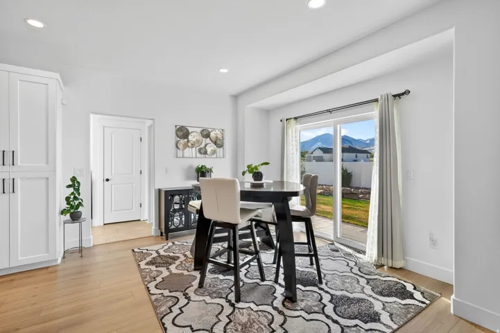 Dining space featuring light wood finished floors and recessed lighting
