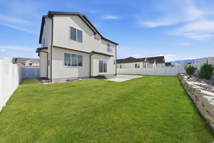 Rear view of property featuring a patio area, a fenced backyard, stucco siding, and a mountain view