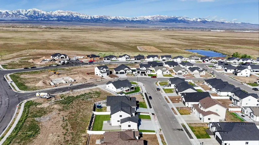 Aerial view of property and surrounding area featuring nearby suburban area