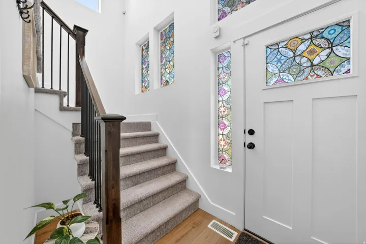 Foyer entrance featuring stairs and light wood finished floors