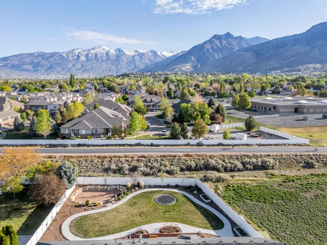 View of mountain backdrop featuring nearby suburban area
