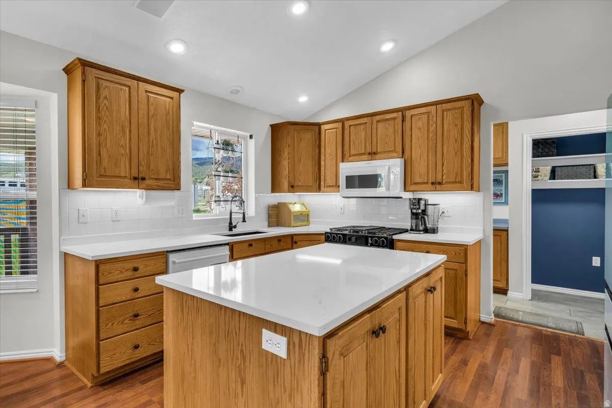 Updated kitchen with vaulted ceilings, quartz countertops, gas stove.