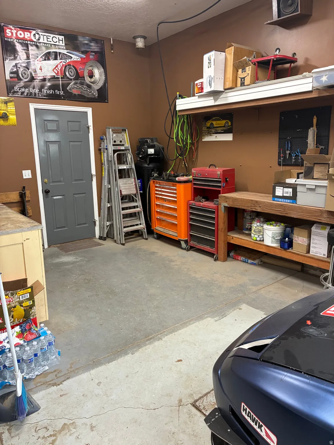 Extra deep 3rd car garage with workbenches and mechanic's pit.