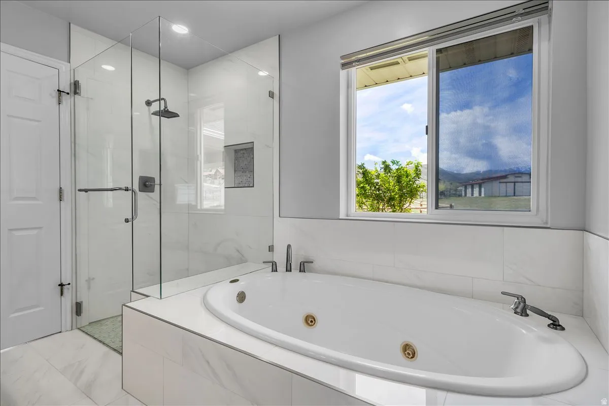 Owner's suite bathroom with double vanity, jetted tub, and separate shower.