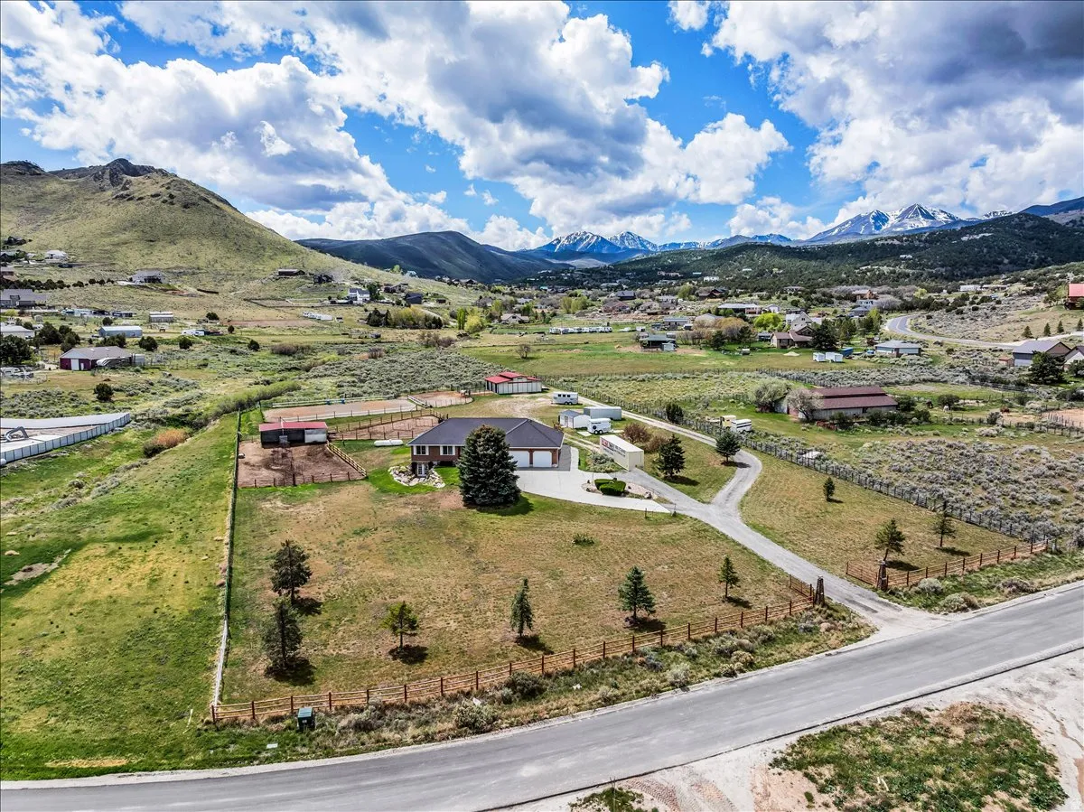 Welcome home to the stunning 7349 Rose Creek Ln! Horse property with 360 views! Aerial view of 2.8 fully-fenced, flat lot - you can use every bit of it!
