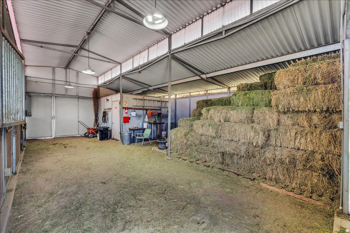 36x36 barn has an arena, 3 stalls, tack room and storage for hay.