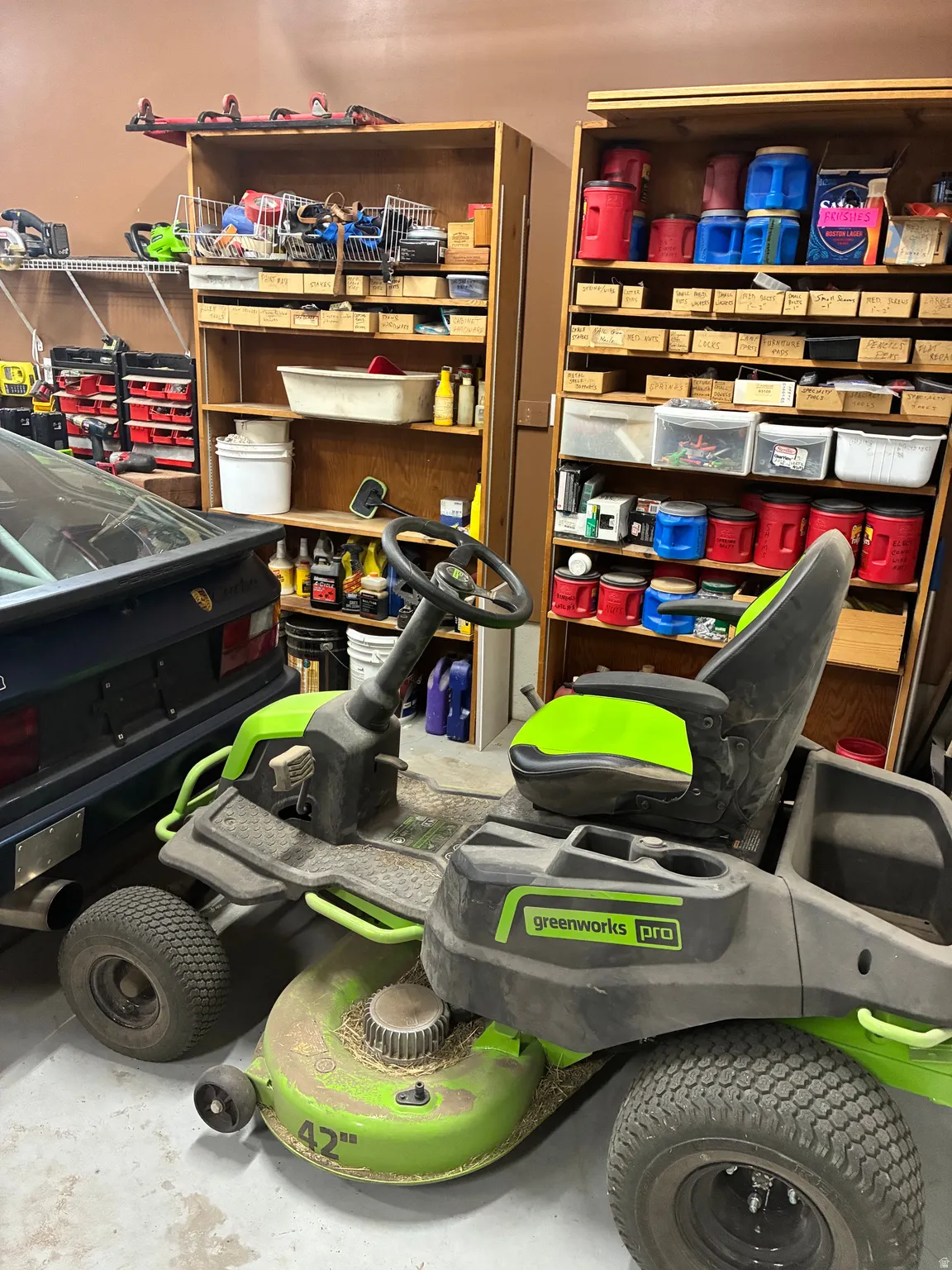 Extra deep 3rd car garage with workbenches and mechanic's pit. Tons of shelves and storage for tools. Riding lawnmower is negotiable.