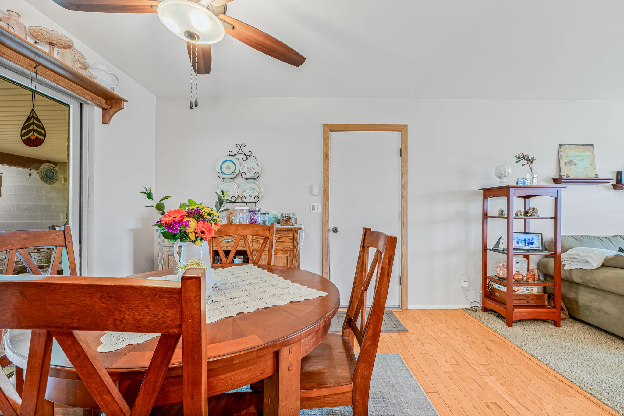 Dining area with hardwood / wood-style flooring and a ceiling fan
