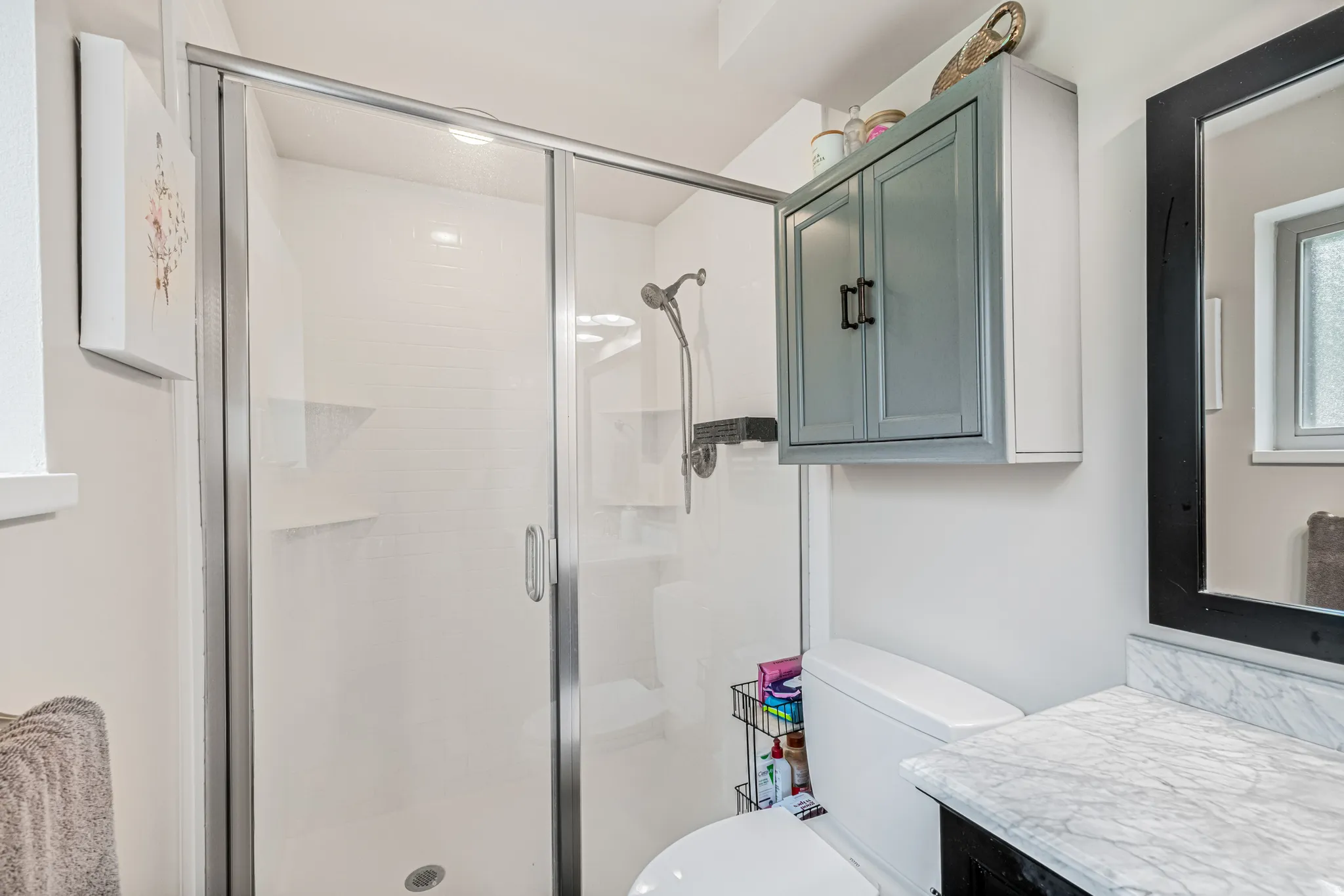 Bathroom with vanity and a stall shower