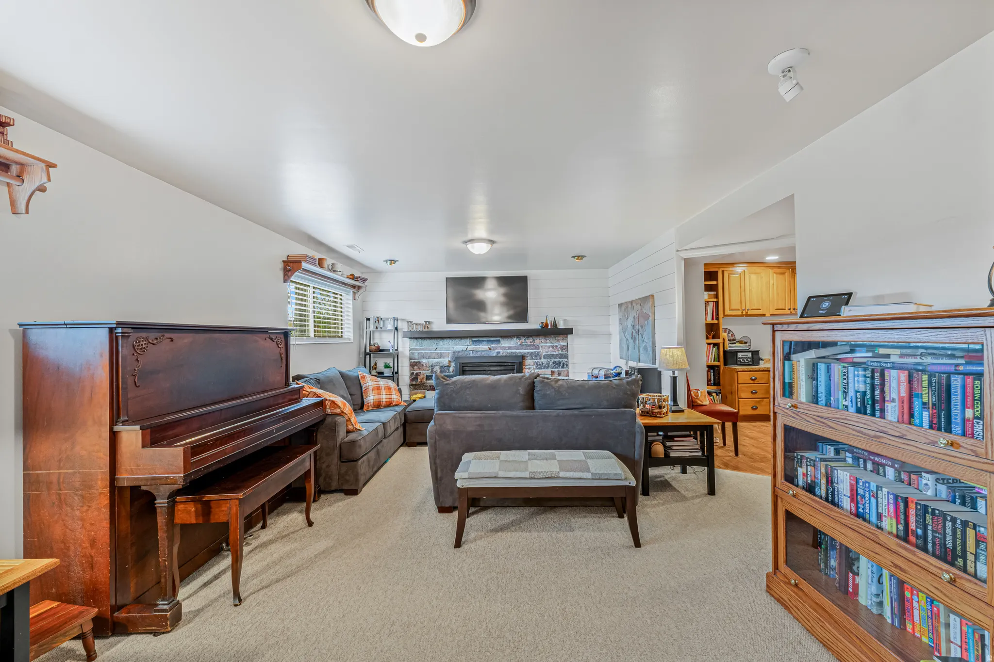 Living room featuring a fireplace, light colored carpet