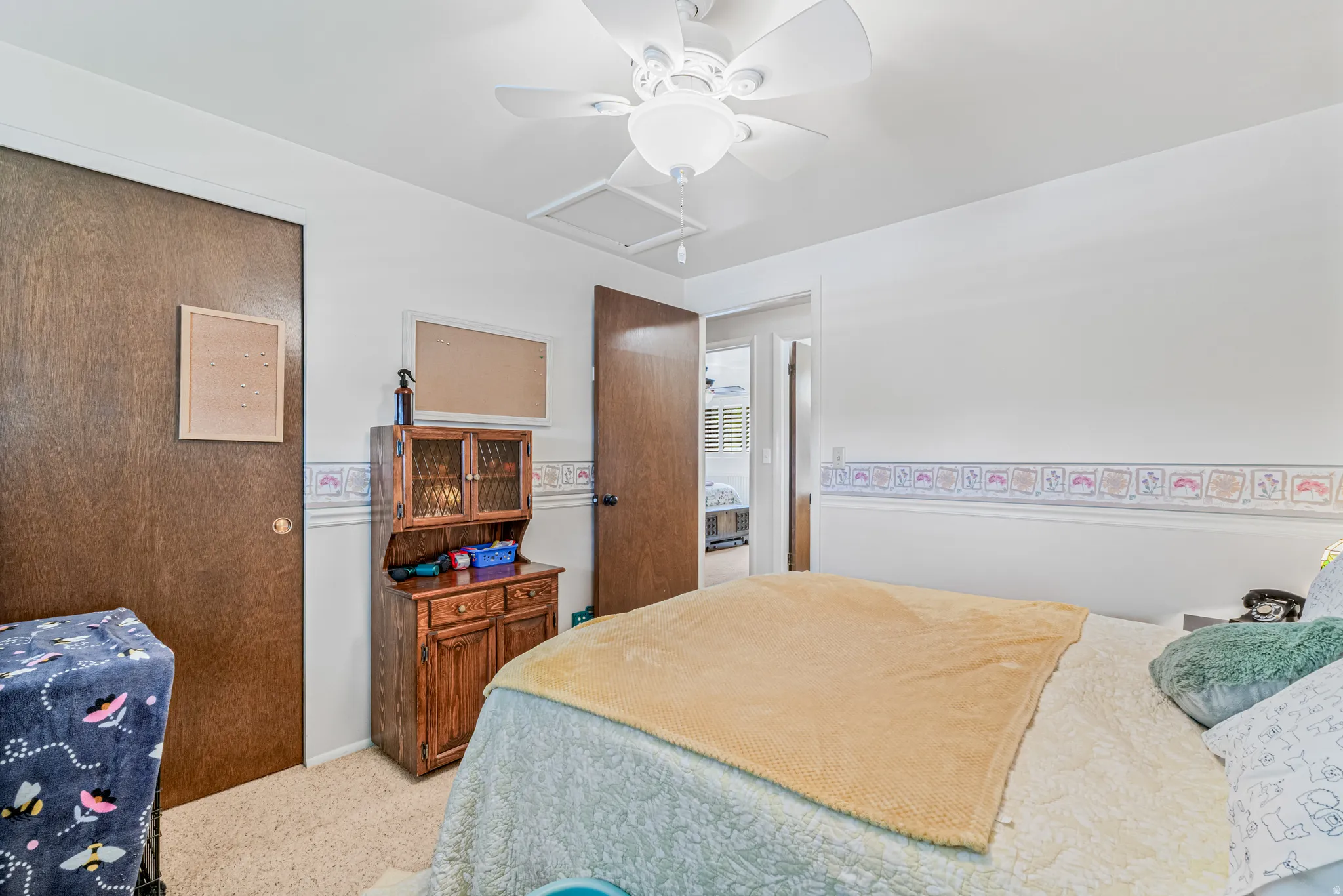 Bedroom featuring ceiling fan and light colored carpet